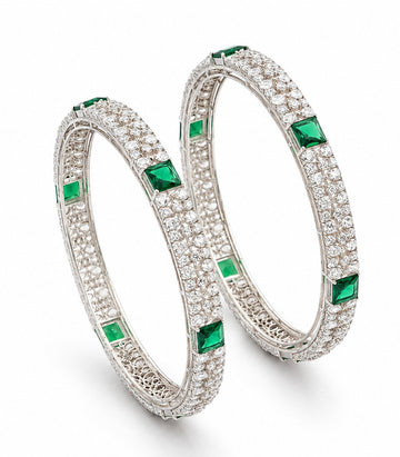 Pair Of Diamond Bangles With Green Gemstones and Foral Patterns