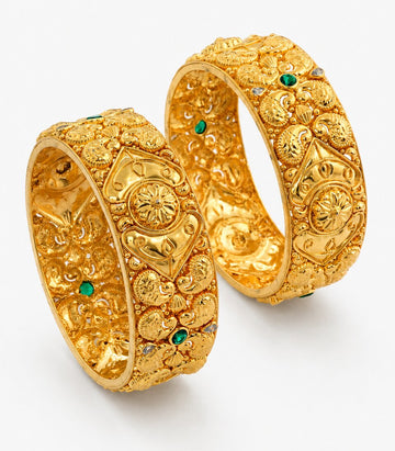 Two Ornate Gold Bangles Embellished With Stunning Green Gemstones