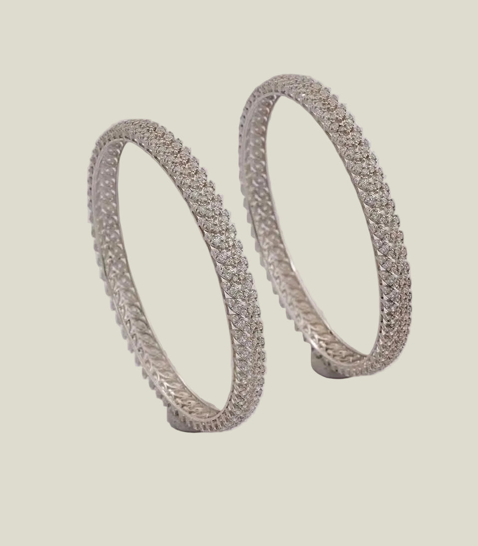 elegant diamond bangles featuring a dense, multi-row pave setting of brilliant-cut diamonds in a classic, shimmering eternity band style.