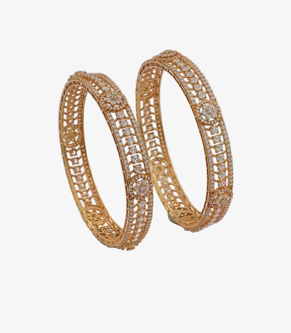 Pair of gold hoop earrings with intricate designs on a light background