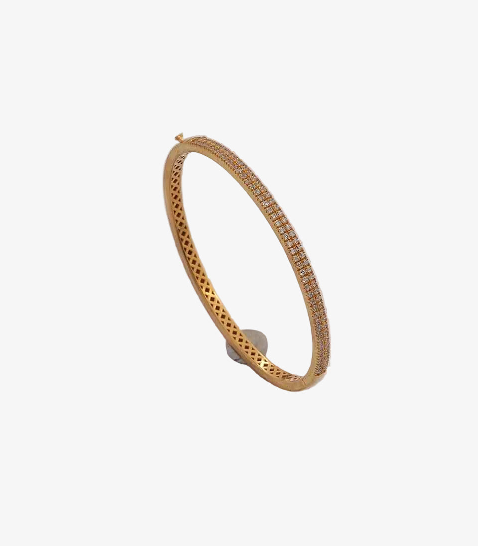 Gold bracelet with small stones on a white background