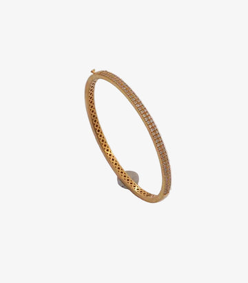 Gold bracelet with small stones on a white background