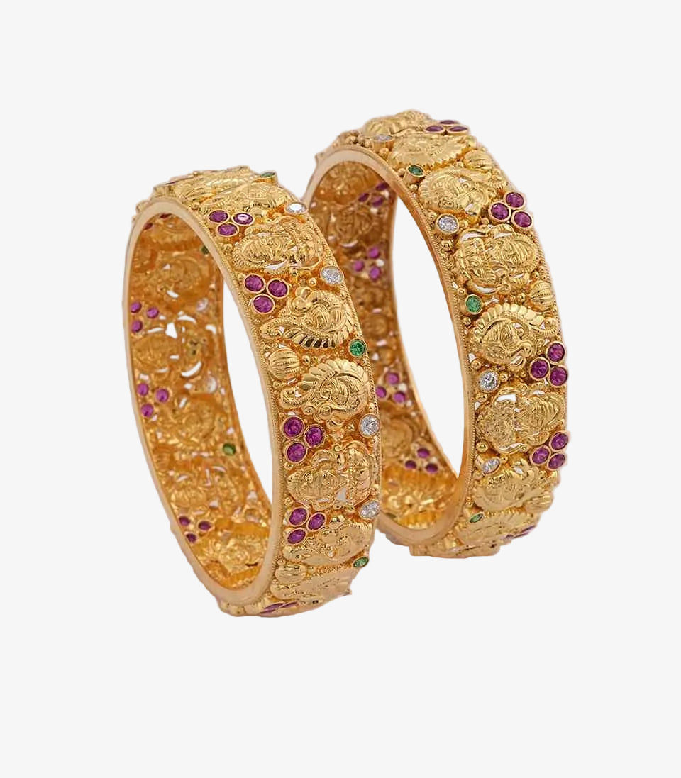 Pair of gold bangles with intricate designs and small green, white and purple stones.