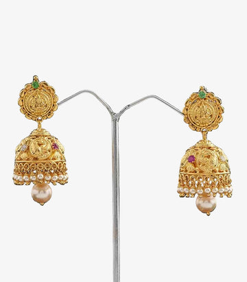 Gold Earrings With Intricate Lakshmi And Pearl Designs on a dark background