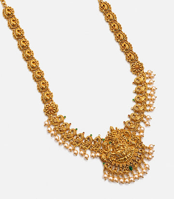 A Long Gold Temple Haram Featuring A Goddess Lakshmi Pendant