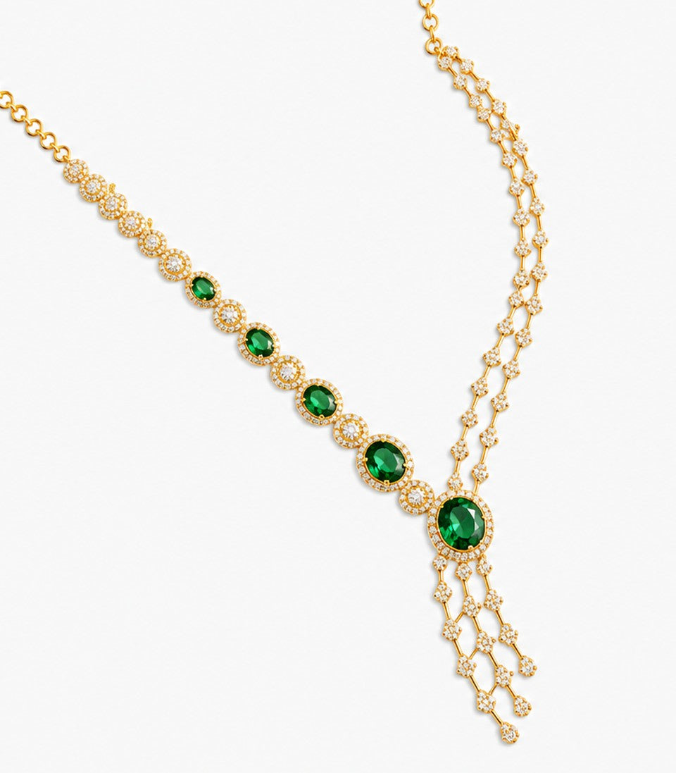 An Elegant Gold Y-Necklace Featuring A Graduated Row Of Oval-Cut Emeralds