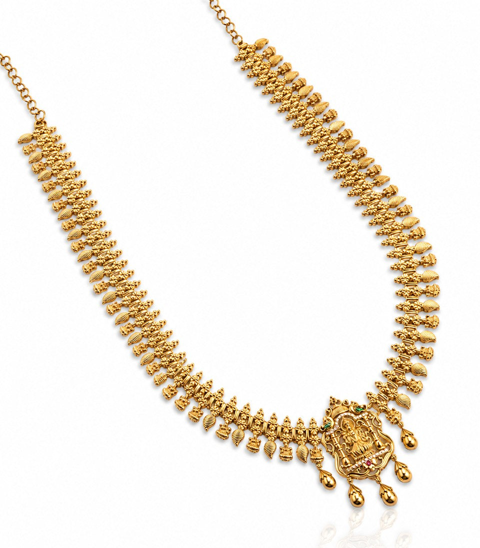 A Long, Ornate Gold Necklace Featuring A Traditional