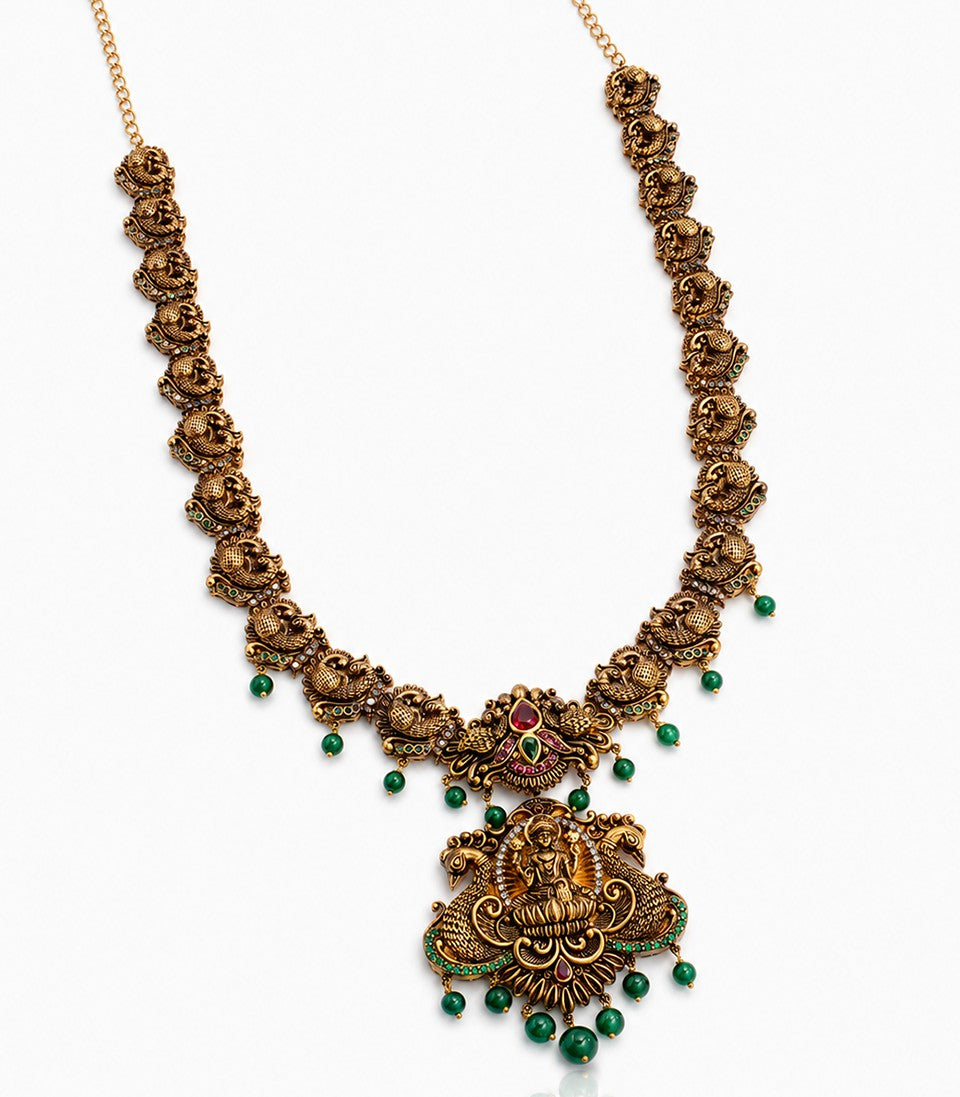 A Long Antique-Finish Gold Haram Featuring A Large Goddess Lakshmi Pendant
