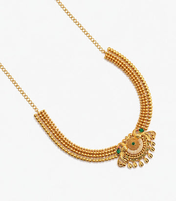 A Long Gold Temple Haram Featuring A Large, Ornate Pendant