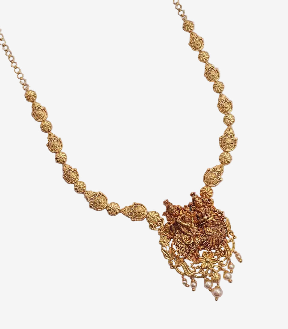 Gold necklace with intricate design on a white background