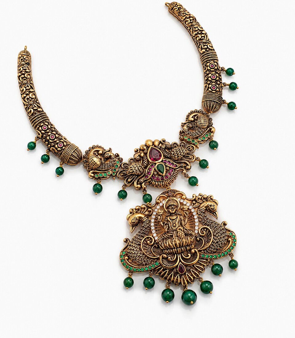 An Antique-Finish Gold Temple Haram Featuring A Large Central Pendant