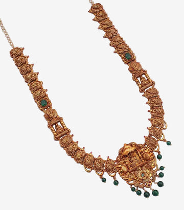 Ornate gold necklace with green beads on a white background