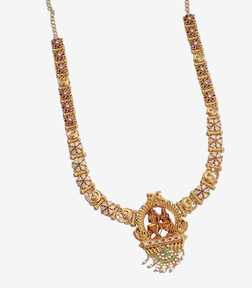 Gold necklace with intricate design on a light gray background