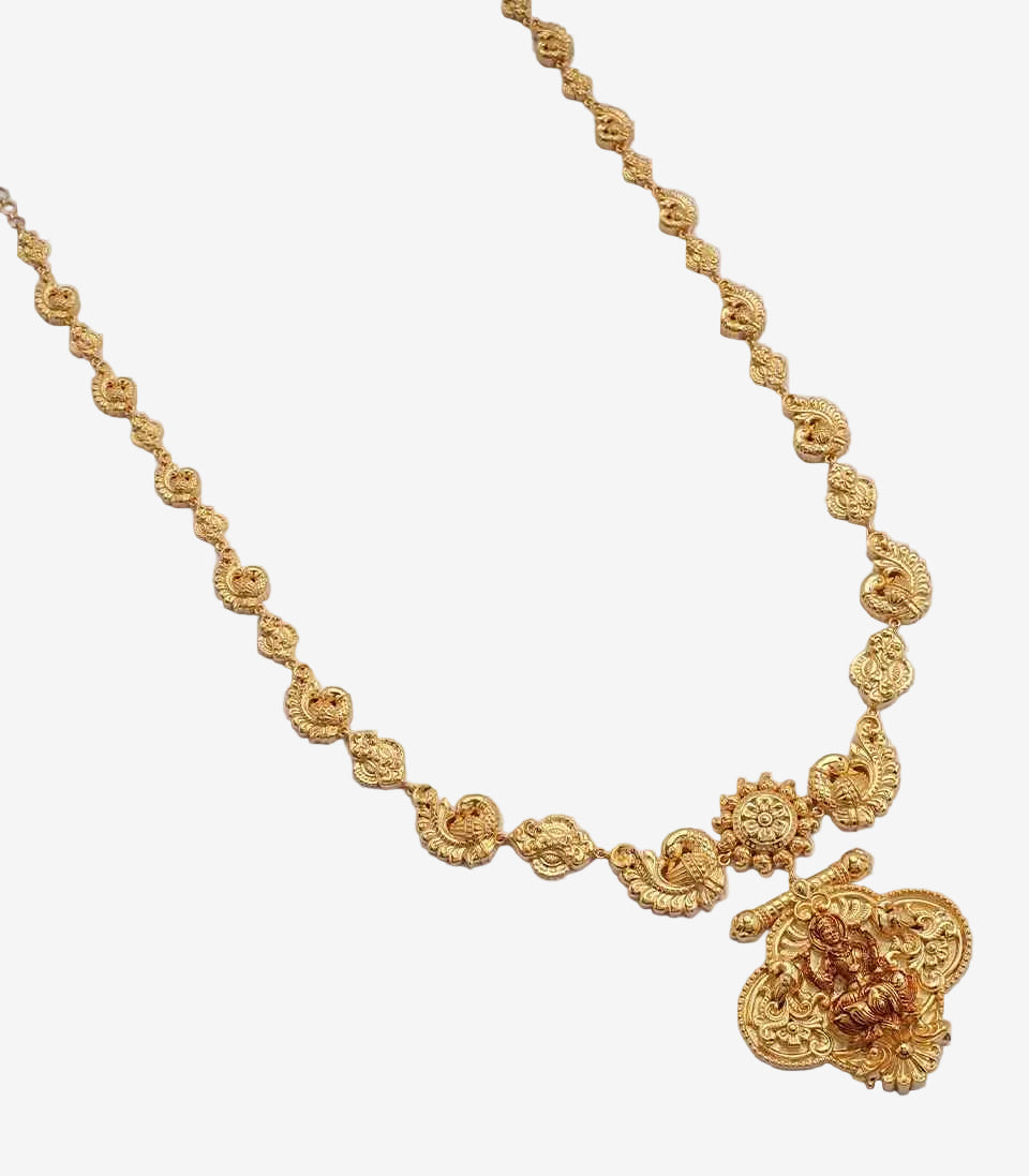 Gold necklace with intricate design on a light gray background
