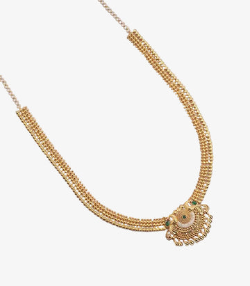 A gold necklace featuring a three-strand beaded chain and an intricate, crescent-shaped pendant embellished with white stones, green accents, and dangling gold droplets.