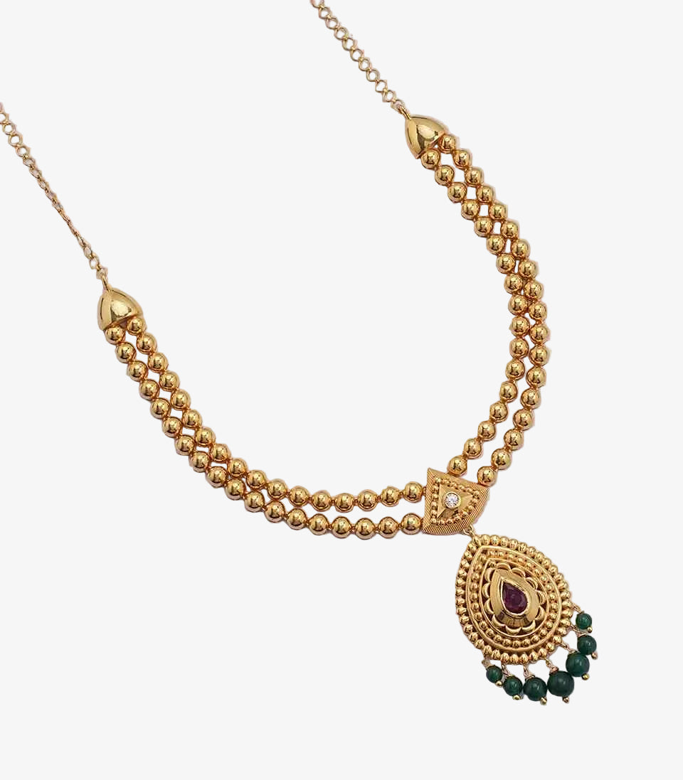 A gold haram featuring a large circular pendant with peacock motifs and a central green stone, attached to a traditional manga malai chain of paisley motifs.