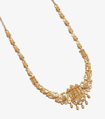 A long gold necklace featuring a chain of stylized floral and peacock links, with a rectangular temple-style pendant depicting a deity, flanked by peacock motifs and finished with small dangling gold droplets.