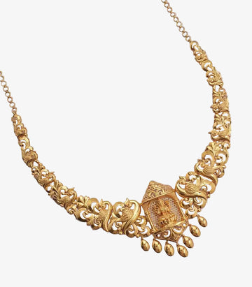 An ornate yellow gold necklace featuring a central temple-style pendant with a seated deity, flanked by intricate peacock and floral filigree motifs with dangling gold beads.