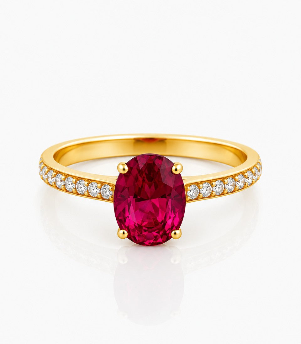 Gold Ring With A Red Gemstone And Diamond Accents