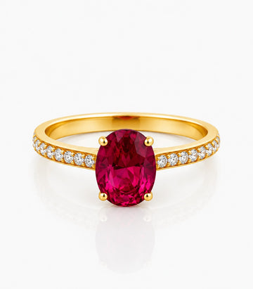 Gold Ring With A Red Gemstone And Diamond Accents