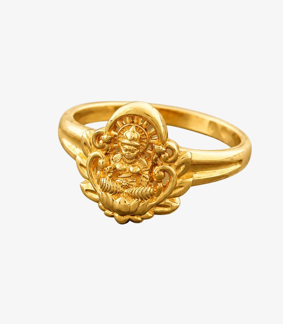 Gold ring with intricate design on a white background