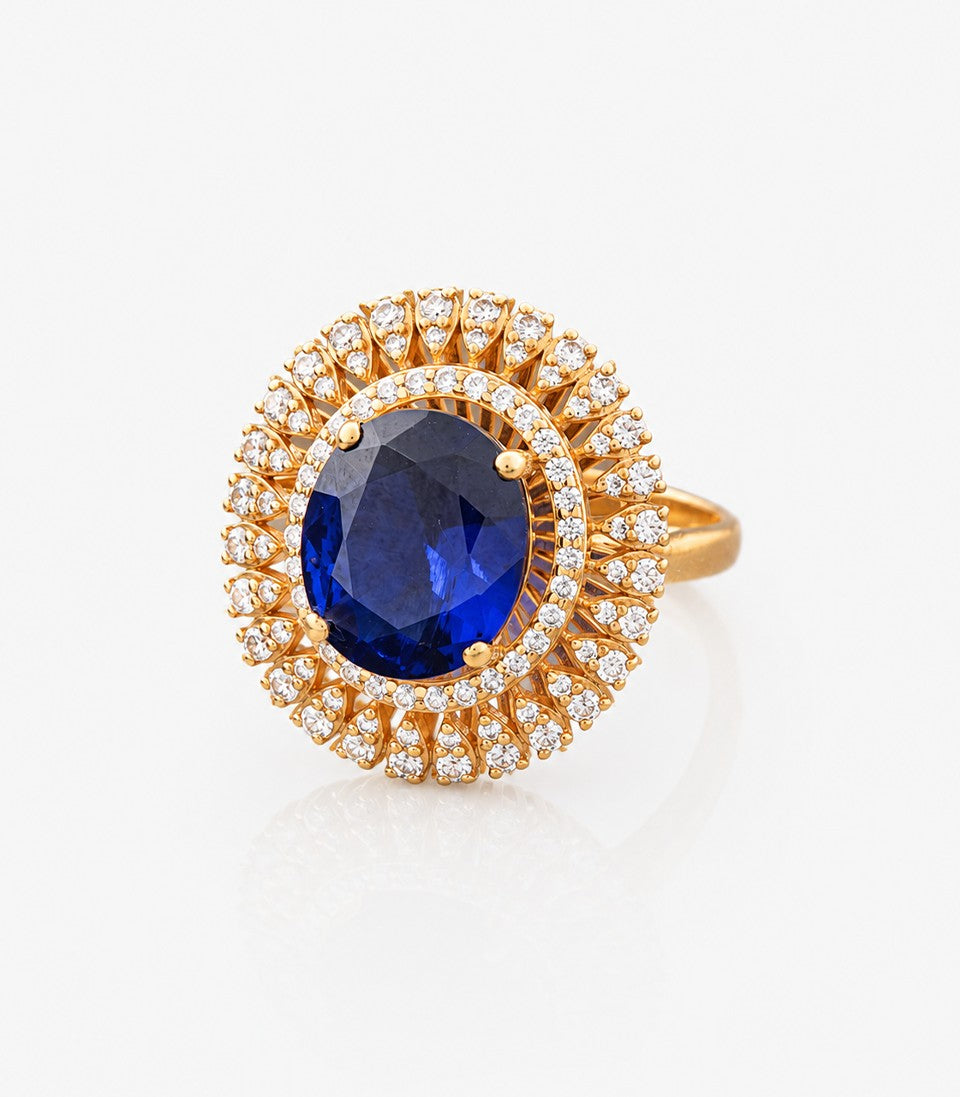 Gold Ring With A Blue Gemstone And Diamond Accents