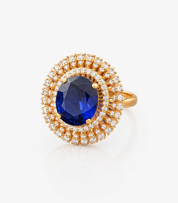 Gold Ring With A Blue Gemstone And Diamond Accents