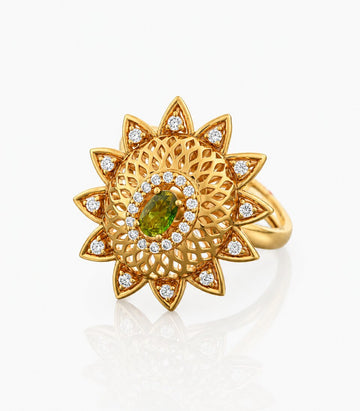 Gold Ring With Intricate Design And Green Gemstone on a white background